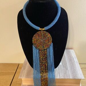 Elegant Blue Necklace with Gold Pendant and Tassels